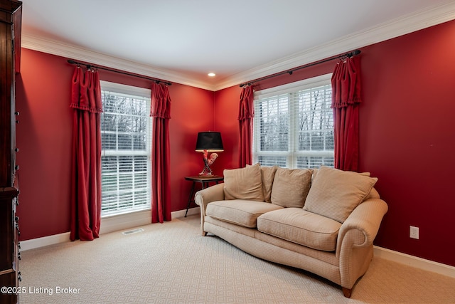 carpeted living area featuring crown molding, visible vents, and baseboards