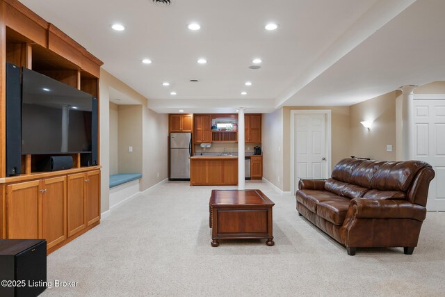 living area featuring recessed lighting, baseboards, light carpet, and ornate columns