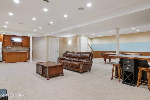 living area featuring recessed lighting, light colored carpet, and baseboards