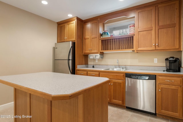 kitchen with a center island, open shelves, stainless steel appliances, light countertops, and a sink