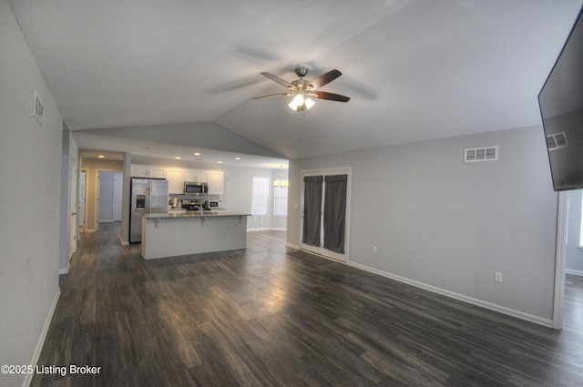 unfurnished living room with ceiling fan, lofted ceiling, and dark hardwood / wood-style floors