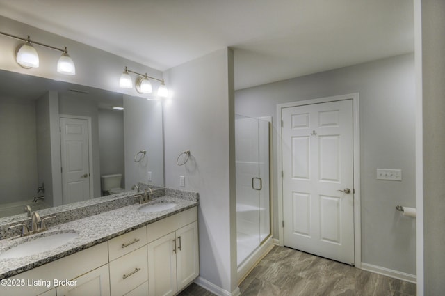 bathroom with vanity, wood-type flooring, toilet, and walk in shower