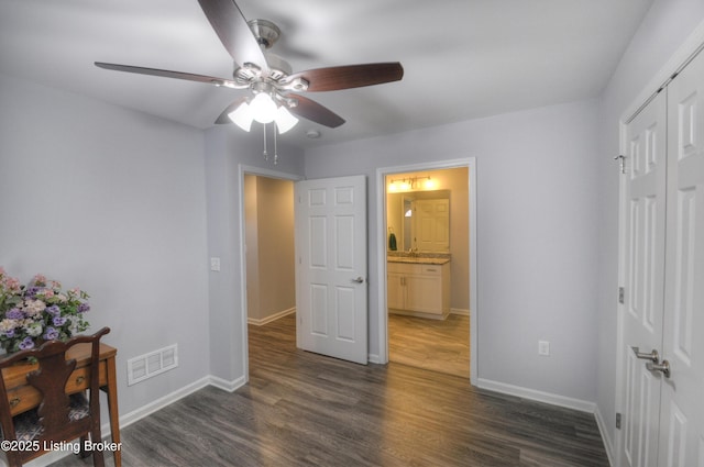 bedroom with dark hardwood / wood-style floors, ceiling fan, and a closet