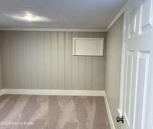 spare room with ornamental molding, carpet flooring, and a textured ceiling