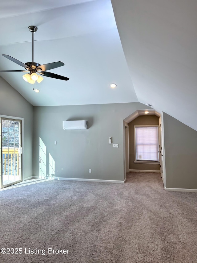 interior space with lofted ceiling, a wall mounted air conditioner, light colored carpet, and ceiling fan