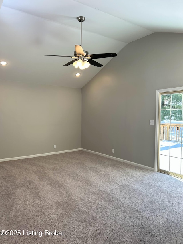 spare room with ceiling fan, carpet flooring, and vaulted ceiling