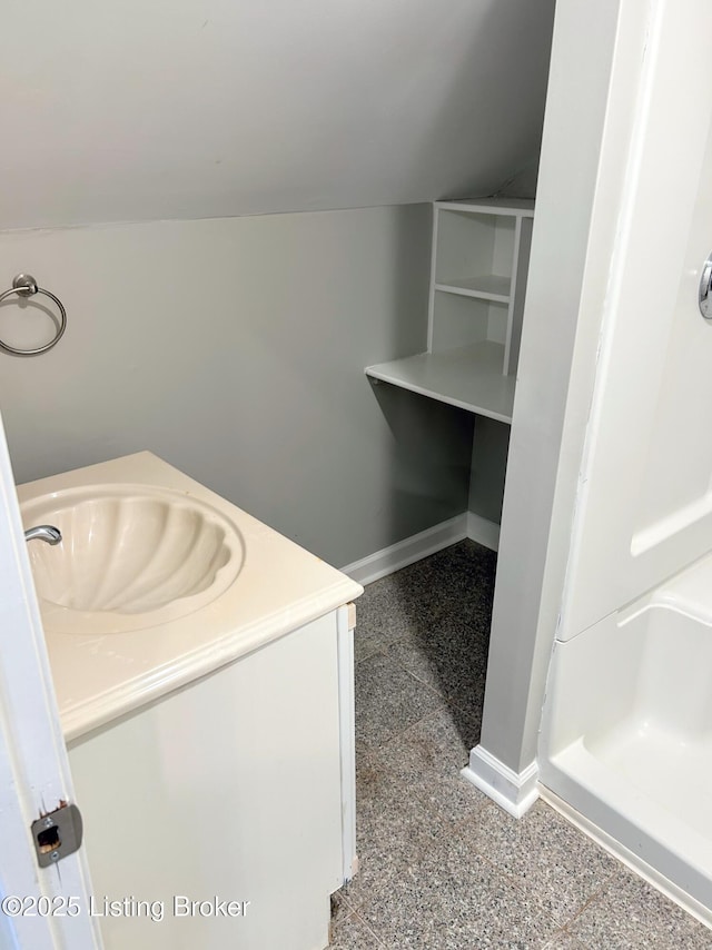 bathroom with vanity and vaulted ceiling