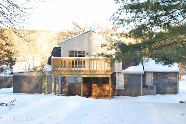 snow covered property featuring a wooden deck