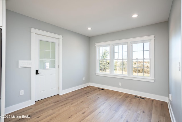 unfurnished room with light hardwood / wood-style flooring