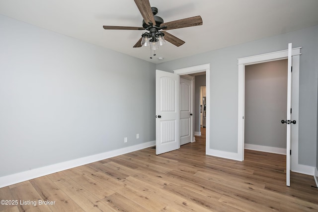 unfurnished bedroom with ceiling fan, light wood-type flooring, and a closet