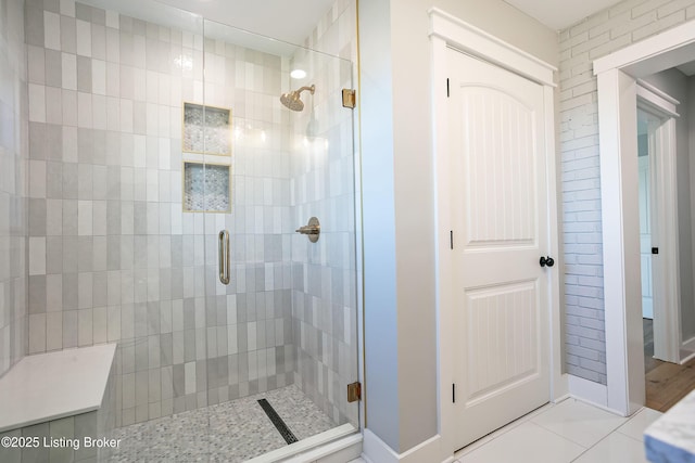 bathroom featuring an enclosed shower and tile patterned flooring