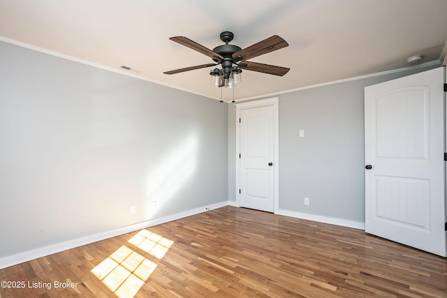 unfurnished bedroom featuring crown molding, ceiling fan, and hardwood / wood-style floors