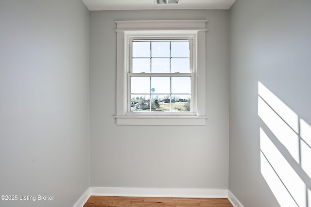 spare room with hardwood / wood-style floors