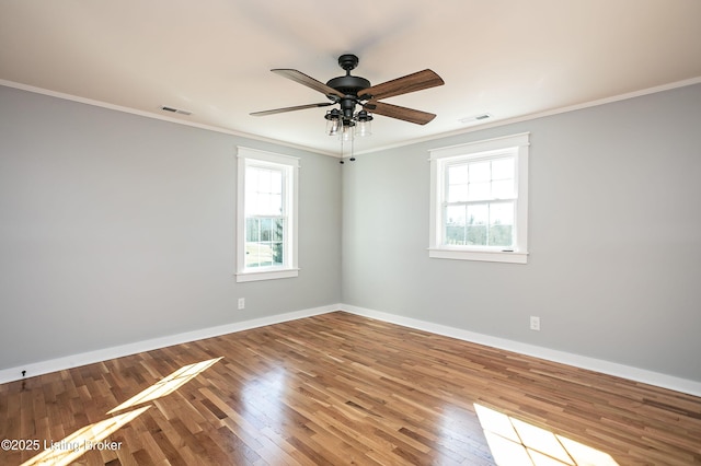 spare room featuring hardwood / wood-style flooring, crown molding, and ceiling fan