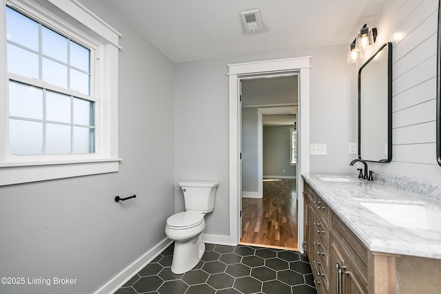 bathroom featuring tile patterned flooring, vanity, and toilet