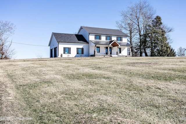 view of front of house featuring a front yard and covered porch