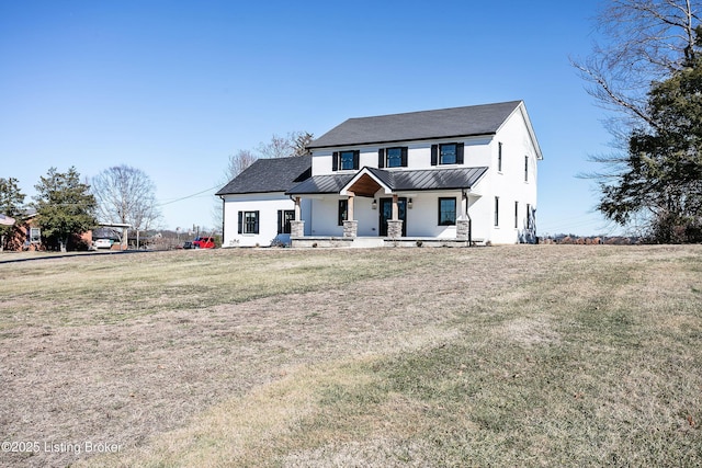 modern farmhouse with covered porch and a front yard