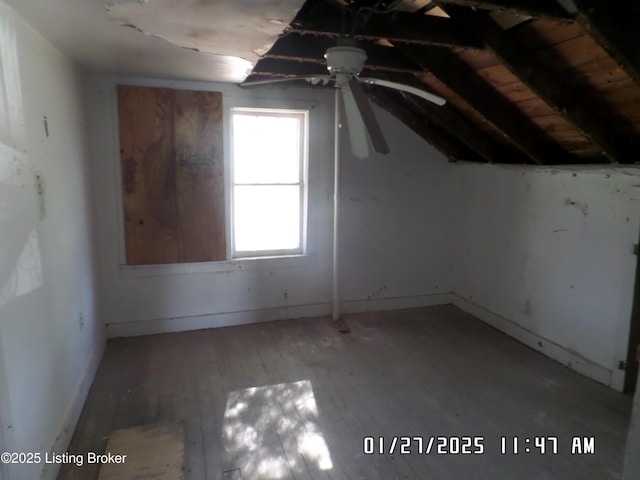 bonus room with hardwood / wood-style flooring and vaulted ceiling