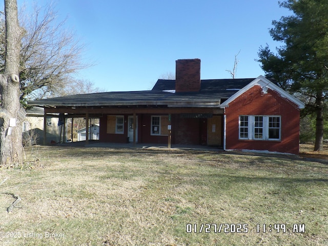 rear view of house with a lawn