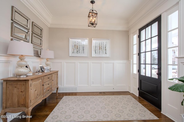 interior space with crown molding, dark hardwood / wood-style floors, and a chandelier