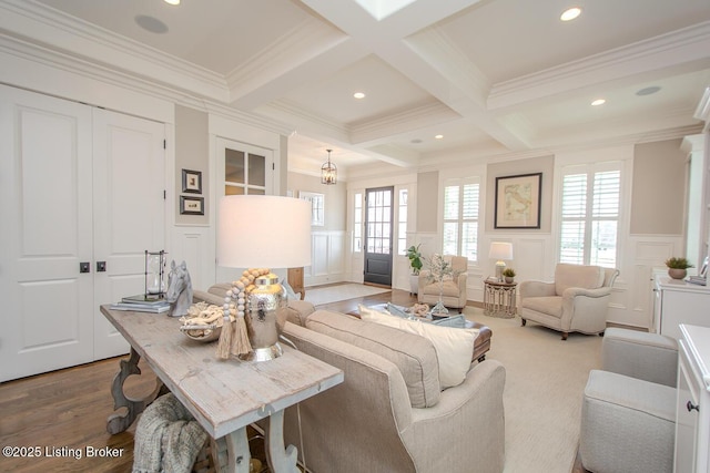 living room with beamed ceiling, crown molding, wood-type flooring, and coffered ceiling