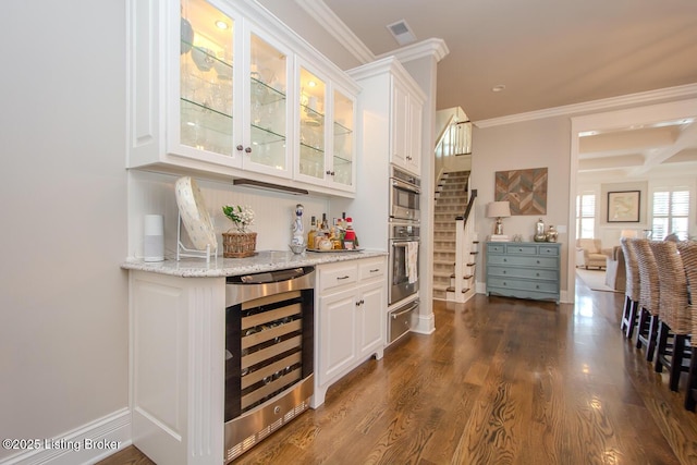 bar with white cabinets, light stone countertops, dark hardwood / wood-style floors, and wine cooler