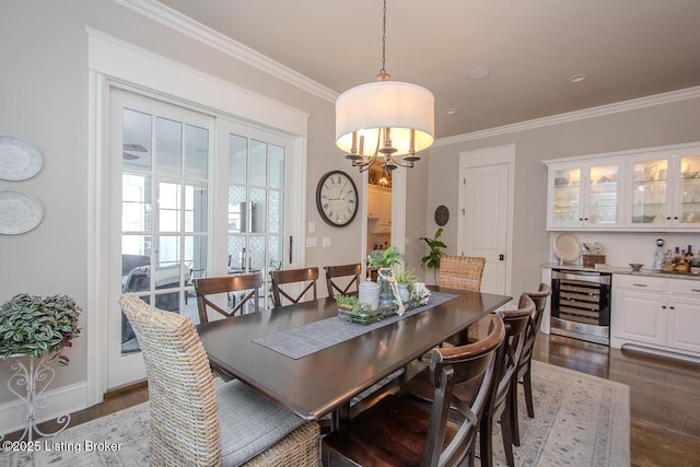 dining room with wine cooler, indoor bar, dark hardwood / wood-style floors, and crown molding