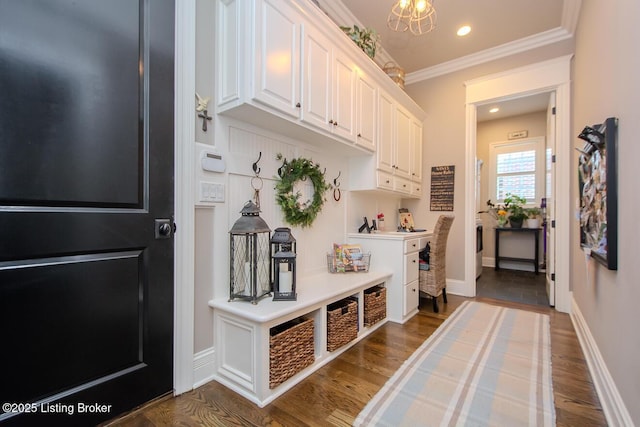 mudroom with an inviting chandelier, hardwood / wood-style floors, and crown molding