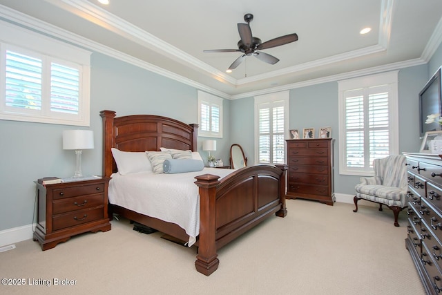 carpeted bedroom with crown molding, ceiling fan, and a raised ceiling