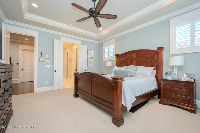 carpeted bedroom featuring crown molding, ceiling fan, and a tray ceiling