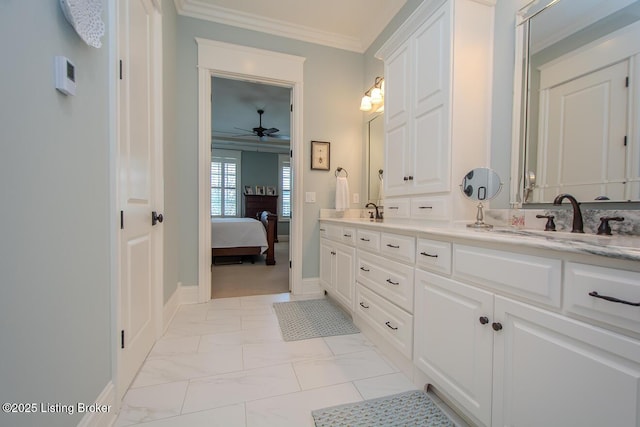 bathroom featuring ceiling fan, ornamental molding, and vanity