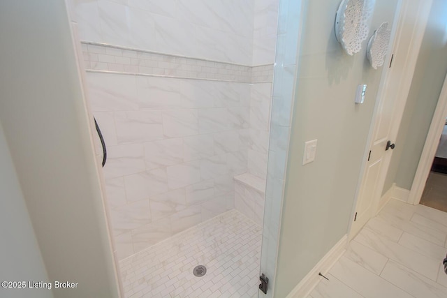 bathroom with a tile shower