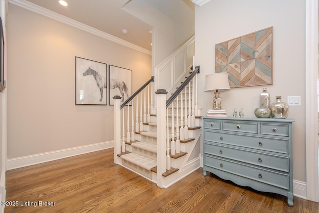 staircase with ornamental molding and wood-type flooring