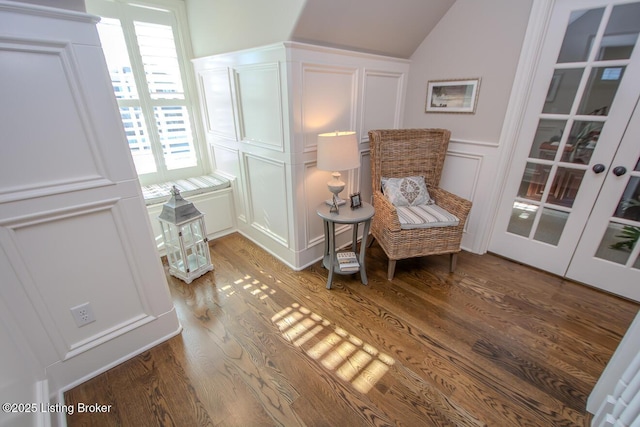 sitting room featuring wood-type flooring and lofted ceiling