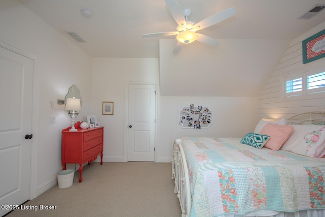 bedroom featuring vaulted ceiling, light colored carpet, and ceiling fan