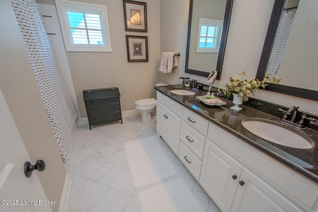 bathroom featuring vanity, plenty of natural light, curtained shower, and toilet