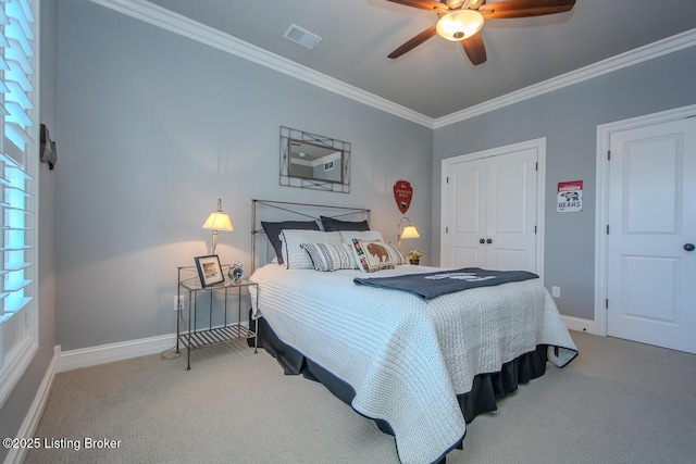 carpeted bedroom featuring crown molding, ceiling fan, and a closet