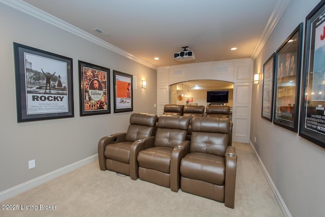 home theater room with light colored carpet and ornamental molding