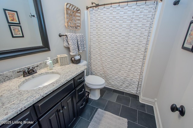 bathroom with vanity, curtained shower, tile patterned floors, and toilet