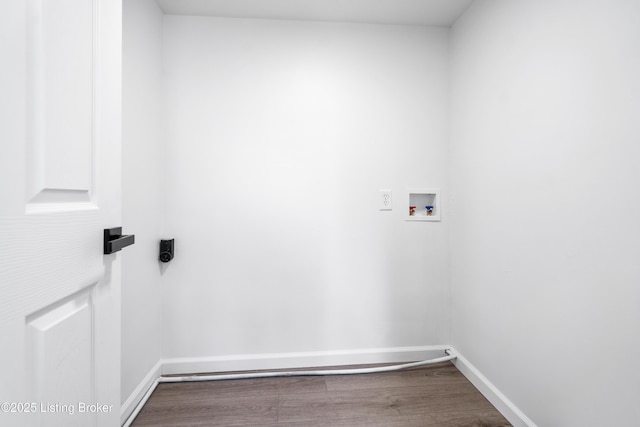 clothes washing area with hardwood / wood-style flooring and washer hookup