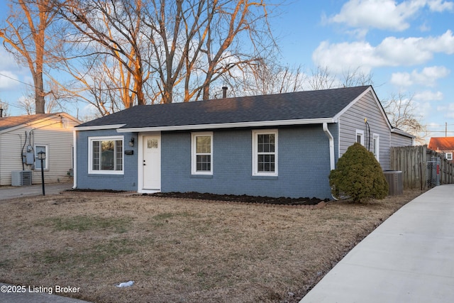 ranch-style house with central AC and a front lawn