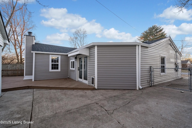 back of house featuring a wooden deck