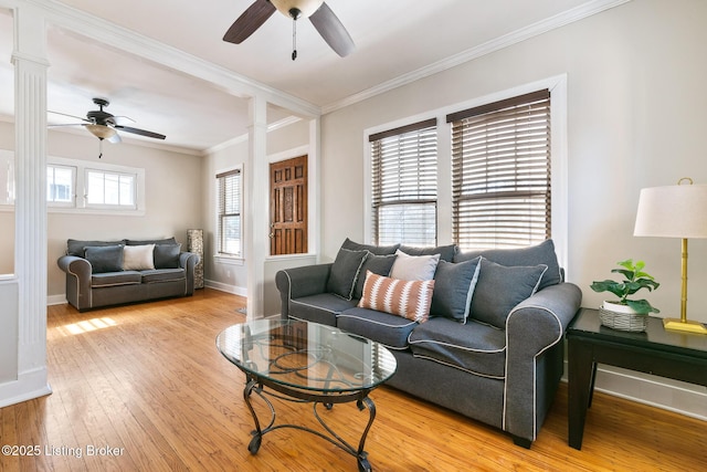 living room featuring crown molding, ornate columns, ceiling fan, and light wood-type flooring