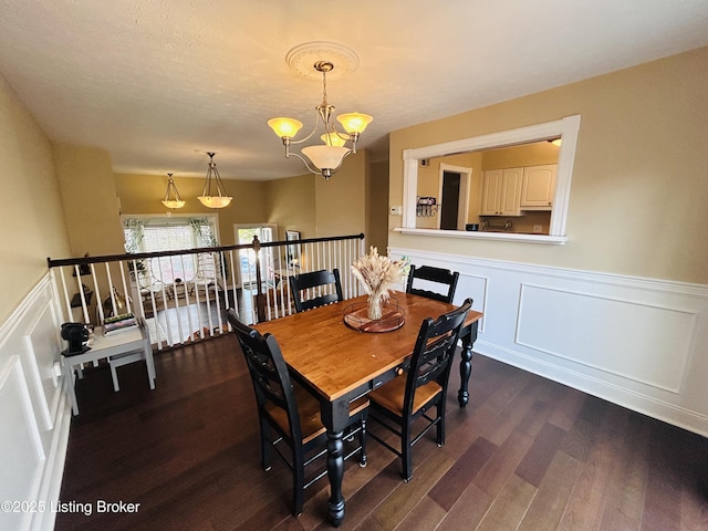 dining area featuring a notable chandelier and dark hardwood / wood-style floors