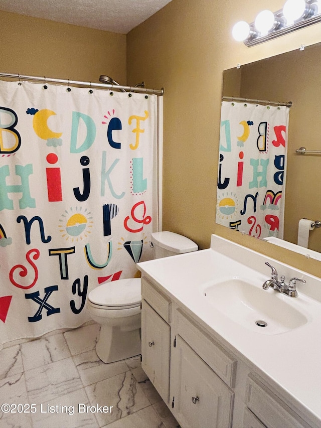 bathroom featuring vanity, a textured ceiling, a shower with curtain, and toilet