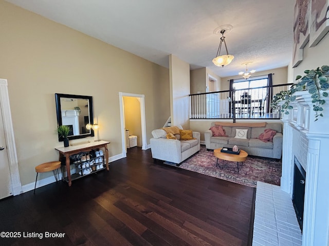 living room with hardwood / wood-style flooring and a notable chandelier