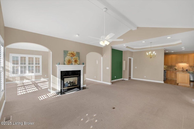 unfurnished living room with visible vents, baseboards, light colored carpet, beamed ceiling, and a high end fireplace