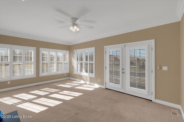 unfurnished sunroom with a healthy amount of sunlight, ceiling fan, and french doors