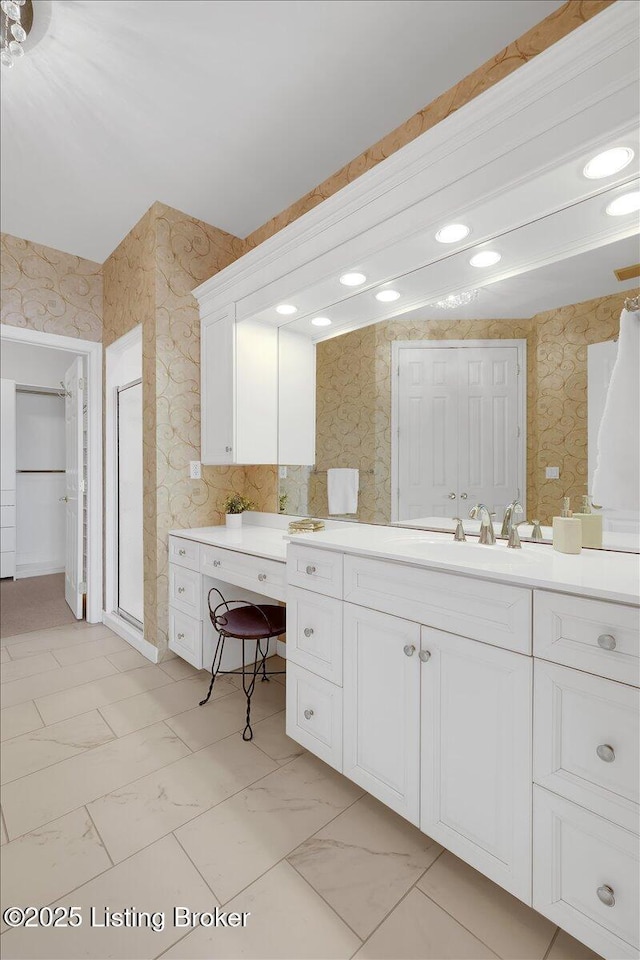 full bathroom with wallpapered walls, a shower, lofted ceiling, marble finish floor, and vanity