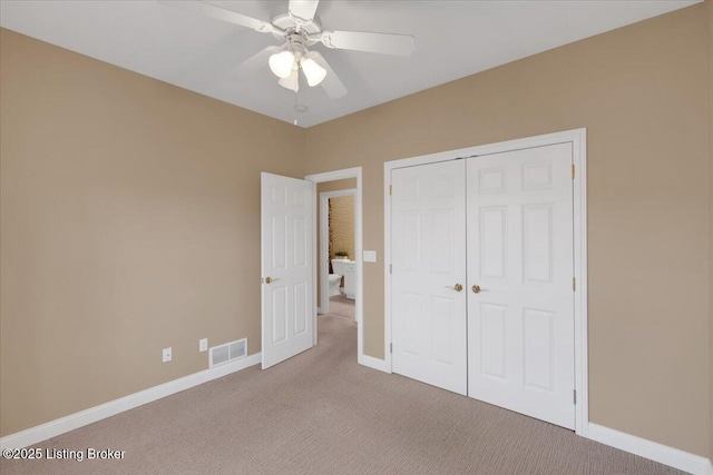 unfurnished bedroom featuring a closet, visible vents, a ceiling fan, carpet flooring, and baseboards